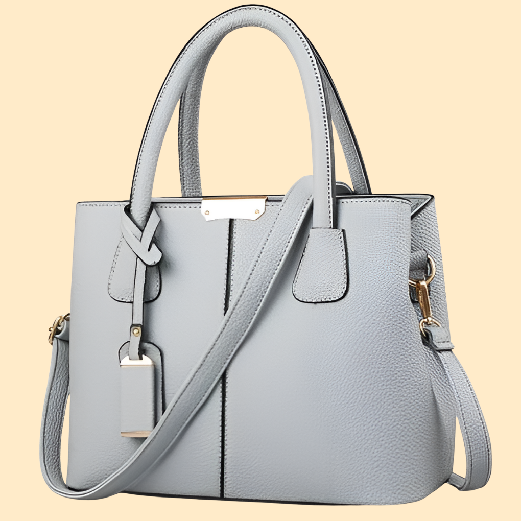 Bolso de mano estructurado con detalle de flecos