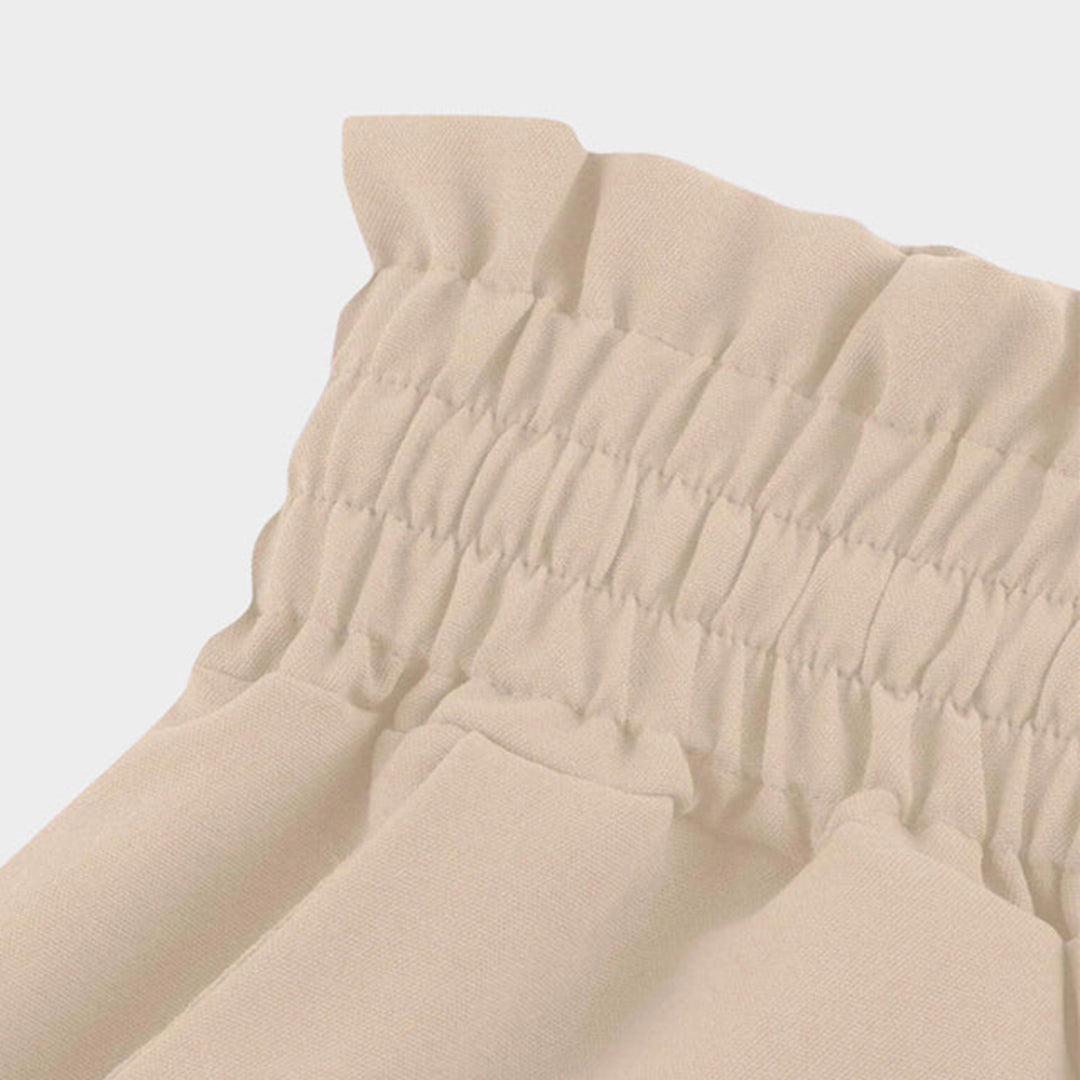 Pantalón largo y fluido de tiro alto con cintura elástica, cordón de ajuste, corte en A y bolsillos
